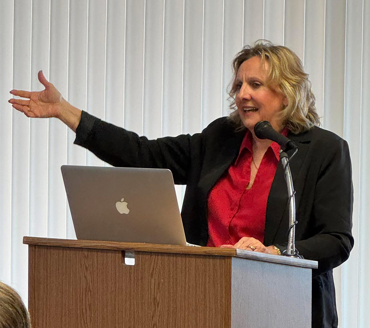 Lori Shultz speaking at a podium
